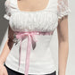 Top patchwork in pizzo bianco con fiocco Y2K e maniche a palloncino