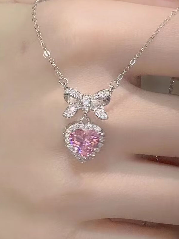 Collana con ciondolo a forma di cuore con fiocco glitterato rosa Y2K