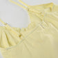 Top giallo vintage con scollo a V e volant sull'orlo