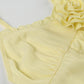 Top giallo vintage con scollo a V e volant sull'orlo