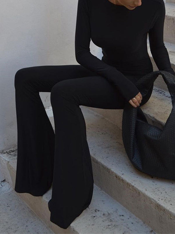 Black vintage jumpsuit with long sleeves and flared legs