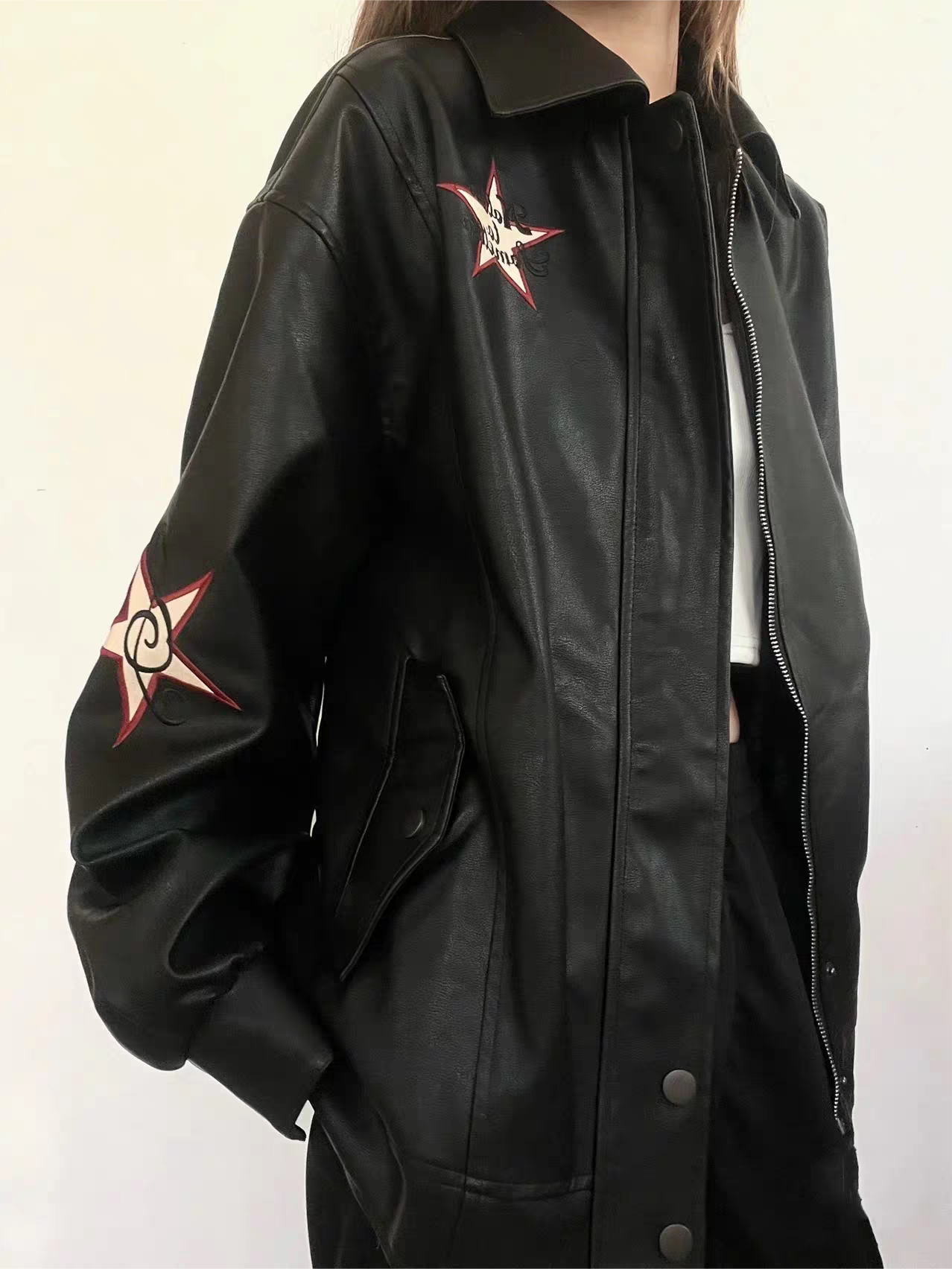 Black leather jacket with lapel collar and embroidery