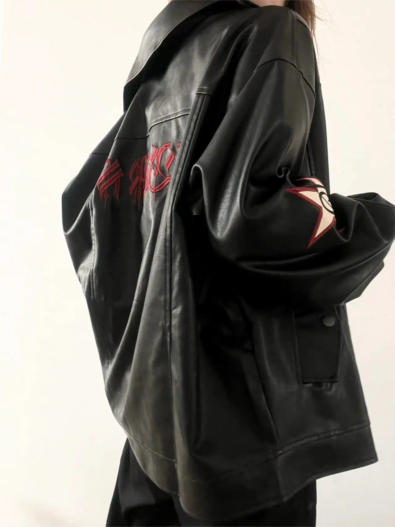 Black leather jacket with lapel collar and embroidery